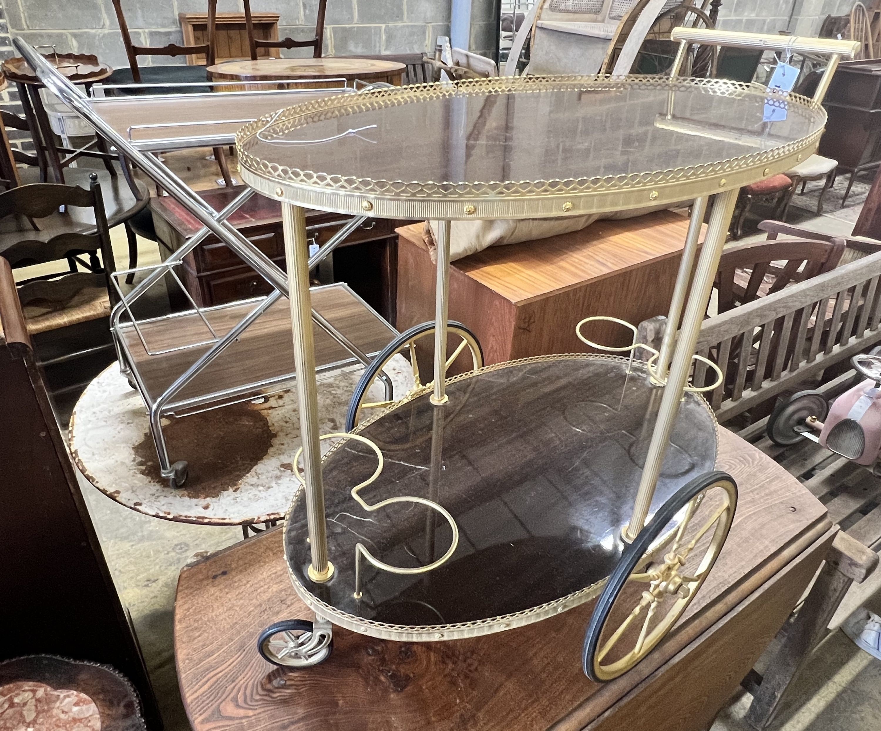 An oval gilt metal tea trolley, height 79cm, together with a smaller chrome folding tea trolley